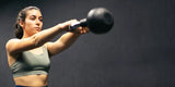A woman in her twenties/thirties lifting a weight, indicating strength and the ability to go to a gym in relation to using Uresta.