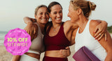 Three women on a beach in active wear, holding a yoga mat. The burst reads: "10% off sitewide. Limited time only."